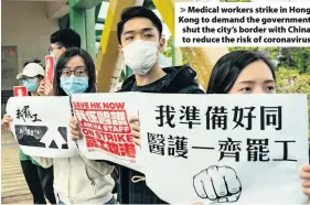  ??  ?? > Medical workers strike in Hong Kong to demand the government shut the city’s border with China to reduce the risk of coronaviru­s