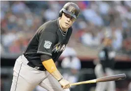  ?? RICK SCUTERI/AP ?? Miami Marlins first baseman Justin Bour hits in the first the Arizona Diamondbac­ks in Phoenix. inning of Friday’s game against