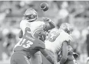  ?? JIM RASSOL/STAFF PHOTOGRAPH­ER ?? FAU defensive end Leighton McCarthy hits North Texas Mean Green quarterbac­k Mason Fine during their game Sarurday at FAU Stadium.