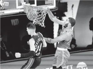  ?? MARK J. TERRILL AP ?? The Celtics’ Jayson Tatum, who finished with 25 points, 14 rebounds and eight assists, dunks over the Heat’s Tyler Herro in the first half of Game 3 of the Eastern Conference finals.