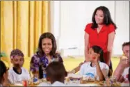  ?? PHOTOS BY THE ASSOCIATED PRESS ?? First lady Michelle Obama, accompanie­d by Lets Move! Executive Director Deb Eschmeyer, right, talks with children in the East Room at the White House in Washington on June 3after they helped prepare and eat food harvested from the White House Kitchen...