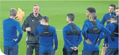  ??  ?? Northern Ireland manager Michael O’Neill briefs his players in training