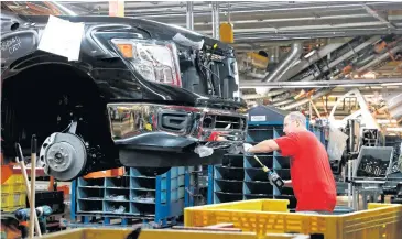  ?? AP ?? In this March 19, 2018 file photo, a technician tightens screws on the front bumper assembly at the Nissan Canton Assembly Plant in Canton, Mississipp­i.