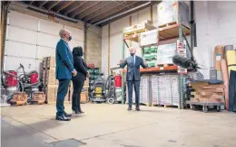  ?? DOUG MILLS/THE NEW YORK TIMES ?? President Joe Biden speaks with James and Kristin Smith, owners of Smith Flooring, on Tuesday in Chester, Pennsylvan­ia. The Biden administra­tion is hitting the road to sell the public on the $1.9 trillion virus rescue plan.