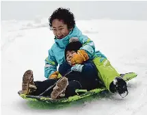  ?? Tyler Sizemore/Hearst Connecticu­t Media ?? Greenwich's Yuito Funayama, 8, and Yuna Funayama, 3, go sledding in Greenwich on Jan. 7.