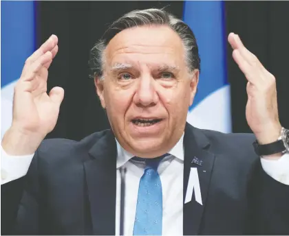  ?? JACQUES BOISSINOT/ THE CANADIAN PRESS ?? “The virus is in every region of Quebec, it's growing and it's dangerous,” Premier François Legault said on Thursday after axing the province's plan for holiday visits. “It will be a quiet Christmas. We won't be able to receive people.”