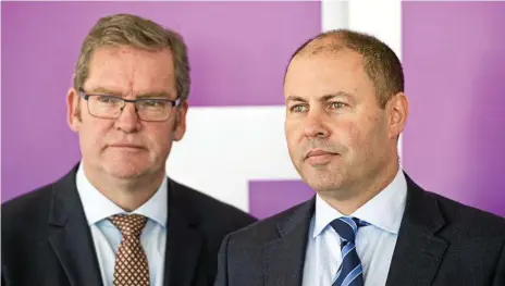  ?? Photo: Nev Madsen ?? QUESTION TIME: Groom MP Dr John McVeigh and (right) Federal treasurer Josh Frydenberg address a media conference following yesterday’s business breakfast at Clifford Park Racecourse in Toowoomba.