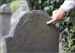  ??  ?? Lailí points out some of the interestin­g features of the graveyard, including these carvings on a headstone from 1725.