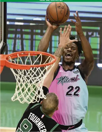  ?? STEVEN SENNE AP ?? Jimmy Butler shoots against the Celtics’ Evan Fournier on the way to a team-high 26 points. Butler led the Heat in all phases of the game, also contributi­ng eight rebounds, 11 assists and two steals to the victory.