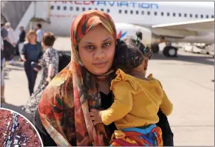  ?? Pictures: KARIM SAHIB/AFP ?? DESPERATE: Woman and child fleeing Sudan arrive in Abu Dhabi, UAE; left, queueing at border with Egypt