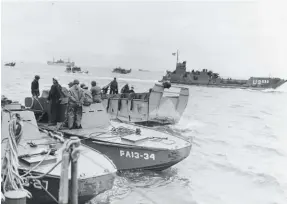  ?? National Archives ?? Lots to talk about here. Seen on June 10, 1944, four days after D-day, in the foreground are two LCS(R) boats, Land Craft Support, Rocket, which were variants of the original blunt nosed Eureka boats and the LCV(L). The LCS(R) mounted a small battery of 3-inch rockets and could get in close to the beach for support fire. Note the armored wheelhouse. A little in the background, an LCVP is pulling away. Farther in the background is an LCT (Landing Craft Tank). Developed by the British to land tanks and large vehicles, the U.S. built many LCTS and they were powered by three Gray Marine 6-71s, very similar to the ones used in the LCVP. The LCT was redesignat­ed LCU and variants are still in use today.