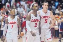  ?? ROBERTO E. ROSALES/JOURNAL ?? From left, Lobos Chris McNeal, Sam Logwood and Joe Furstinger walk off the court in Dreamstyle Arena after a Dec. 16 loss to Arizona. UNM says it’s a different team today than just a month ago.