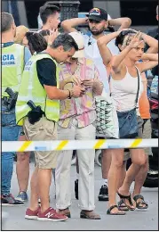  ??  ?? Bystanders led away in Barcelona yesterday