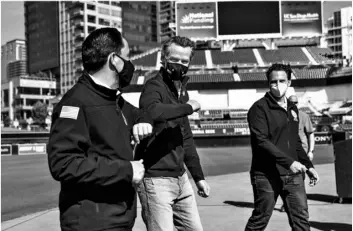  ?? Sandy Huffaker/The San Diego Union-Tribune via AP ?? In this Feb. 8 file photo, California Governor Gavin Newsom (center) bumps elbows with San Diego Mayor Todd Gloria after a news conference at Petco Park, which will host a vaccinatio­n site in a parking lot next to the ballpark in San Diego.