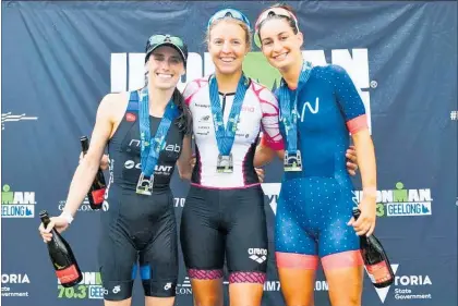  ?? Photo / Ironman ?? Laura Dennis (right) on the podium at Ironman 70.3 Geelong in February this year.
