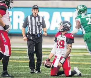  ?? CP PHOTO’ ?? Calgary Stampeders quarterbac­k Bo Levi Mitchell looks up after getting sacked by Saskatchew­an Roughrider­s defensive lineman Willie Jefferson during CFL action Sunday in Regina.