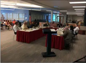  ?? RICHARD PAYERCHIN — THE MORNING JOURNAL ?? Lorain Schools board members, with their staff, attorneys and members of the Lorain Academic Distress Commission, discuss the possibilit­y of placing a levy on the November ballot during their meeting of Aug. ..