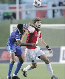  ?? DARREN BROWN/OTTAWA CITIZEN ?? New York Cosmos’ Rovérsio Rodrigues de Barros, left, gets his hands up in Ottawa Fury’s Tom Heinemann’s face during NASL soccer action at TD Place Wednesday.