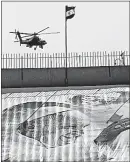  ?? [AMR NABIL/THE ASSOCIATED PRESS] ?? A military helicopter flies over the Air Defense Stadium in Cairo and a giant banner depicting Pope Francis. Military helicopter­s flew overhead and police fanned out in force Saturday as the leader of the Roman Catholic faith led a Mass on Saturday.