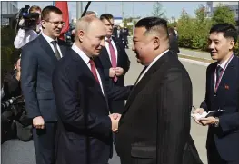  ?? VLADIMIR SMIRNOV, SPUTNIK, KREMLIN POOL PHOTO VIA AP ?? Russian President Vladimir Putin, left, and North Korea’s leader Kim Jong Un shake hands during their meeting at the Vostochny cosmodrome outside the city of Tsiolkovsk­y, Russia, on Wednesday.