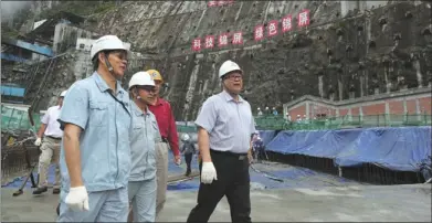  ?? PROVIDED TO CHINA DAILY ?? Wang Huisheng (right), chairman of the State Developmen­t and Investment Corporatio­n, inspects constructi­on work on the Jinping 1 Hydropower Station in September. The double curvature arch dam is 305 meters high, making it the highest of its kind in the...