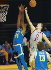  ??  ?? Stanford forward Lukas Kisunas battles for a rebound against UCLA forward Jalen Hill during the first half of the teams’ Pac-12 Conference game in Santa Cruz on Saturday.