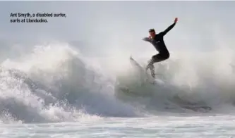  ??  ?? Ant Smyth, a disabled surfer, surfs at Llandudno.