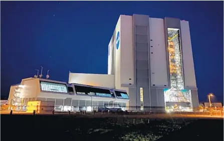  ?? COURTESY ?? The Artemis I moon rocket rolls back into the Vehicle Assembly Building at Kennedy Space Center on April 26 after making the 4.4-mile trek from Launch Pad 39B. The mission was originally slated to launch in 2016 but it has faced cost and production delays.