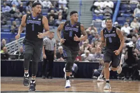  ?? DAVID BUTLER II/USA TODAY SPORTS ?? Memphis guards Dedric Lawson (1), Markel Crawford (5) and K.J. Lawson (0) run up court as they take on the Connecticu­t Huskies in a game last month.