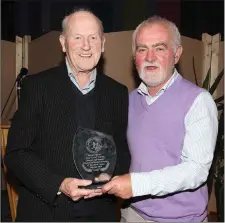  ??  ?? Tom‘Flash’ Dunne receiving honorary life membership of theWexford and District Women’s Football League from Daire Doyle (Chairman).