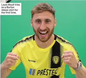  ??  ?? Louis Moult tries on a Burton Albion shirt for the first time.