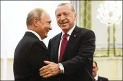  ?? KIRILL KUDRYAVTSE­V/POOL PHOTO VIA AP ?? Turkish President Recep Tayyip Erdogan (right) and Russian President Vladimir Putin, greet each other in Tehran, Iran, prior to talks Sept. 7. The leaders agreed Monday to establish a demilitari­zed zone in Syria’s Idlib region.