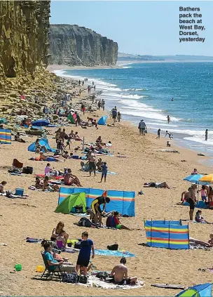  ??  ?? Bathers pack the beach at West Bay, Dorset, yesterday