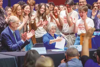  ?? JON AUSTRIA/JOURNAL ?? Gov. Michelle Lujan Grisham signs the gun-related bills on March 4 at a ceremony at West Mesa High School in Albuquerqu­e.