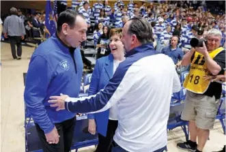  ?? (ETHAN HYMAN/THE NEWS & OBSERVER VIA AP ?? Former Duke head coach Mike Krzyzewski, left, and his wife, Mickie, laugh with Notre Dame head coach Mike Brey, right, before the Feb. 14 game in Durham, N.C.