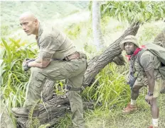  ?? WENN.COM ?? From left to right, Dwayne Johnson, Kevin Hart, and Nick Jonas in a scene from Jumanji: Welcome to the Jungle, which opens on Dec. 20.