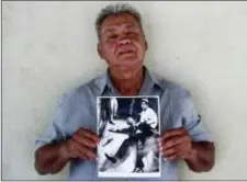  ?? JUD ESTY-KENDALL — STORYCORPS VIA AP ?? In this undated photo provided by StoryCorps, Juan Romero, 67, holds a photo of himself and the dying Sen. Robert F. Kennedy at the Ambassador Hotel in Los Angeles, taken by the Los Angeles Times’ Boris Yaro at his home in Modesto.