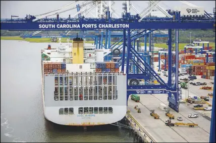  ??  ?? A cargo ship is docked Monday at the port of Charleston, a hub for global trade. Some dockworker­s in Charleston praise President Donald Trump’s efforts on trade, even if it costs some American jobs in the short term.
