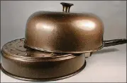  ??  ?? This domed stove-top potato baker also heats dinner rolls and other small items.