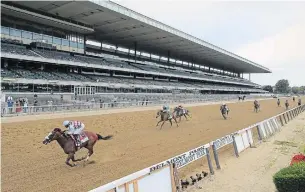  ?? SETH WENIG THE ASSOCIATED PRESS ?? Tiz the Law, with jockey Manny Franco, crosses the finish line in front of an empty grandstand to win the 152nd running of the Belmont Stakes on Saturday in Elmont, N.Y.