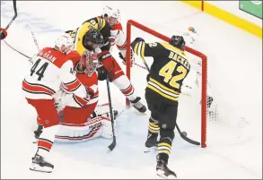  ?? Adam Glanzman / Getty Images ?? The Bruins’ David Backes (42) scores a third-period goal against the Hurricanes’ Petr Mrazek on Sunday.