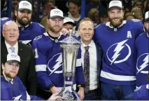  ?? CHRIS O’MEARA — THE ASSOCIATED PRESS ?? Tampa Bay Lightning center Steven Stamkos (91), head coach Jon Cooper, and defenseman Victor Hedman (77) pose with the Prince of Wales Trophy after the team defeated the New York Rangers during Game 6of the Stanley Cup playoffs Eastern Conference finals Saturday, in Tampa, Fla.