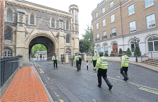  ??  ?? SCENE: Police at the Abbey gateway of Forbury Gardens, where three people were killed in Reading, with a Libyan refugee now in custody