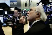  ?? RICHARD DREW — THE ASSOCIATED PRESS ?? Trader Peter Tuchman, right, works on the floor of the New York Stock Exchange, Tuesday.