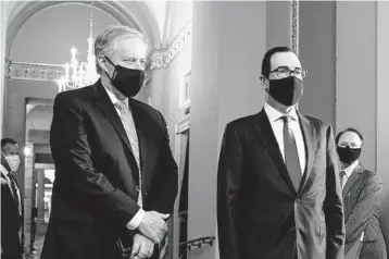  ?? ANNA MONEYMAKER/THE NEW YORK TIMES ?? Acting White House chief of staff Mark Meadows, left, and Treasury Secretary Steven Mnuchin are working on new virus aid.
