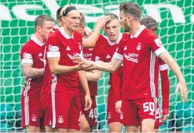  ?? Picture: SNS. ?? The Aberdeen players celebrate Lewis Ferguson’s winning goal from the penalty spot.