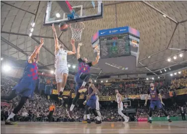  ??  ?? Campazzo trata de atrapar un rebote ante Hanga y Davies en el Barça-Madrid de la Euroliga en el Palau.