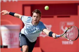  ?? — AFP ?? Austin Krajicek of the US returns to Portugal’s Joao Sousa in their Japan Open second round match in Tokyo on Thursday. Krajicek won 2- 6, 6- 4, 6- 3.