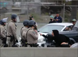  ?? ARIC CRABB — BAY AREA NEWS GROUP ?? A protester yells at police officers after shutting down traffic along northbound Interstate 880 near the 5th Street exit on Monday in Oakland, California.