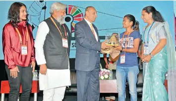  ?? P. SURENDRA ?? Governor E.S.L. Narasimhan (centre) felicitate­s mountainee­r Malavath Purna with the Telangana Jagruthi Young achievers award at the Telangana Jagruthi Internatio­nal Youth Leadership Conference on Sunday. TRS MP K. Kavitha (right), wrestler Babita Phogat (left), ‘Waterman of India’ Dr Rajendra Singh (second from left) are also seen. The Governor stressed on the importance of the youth and gender equality. —